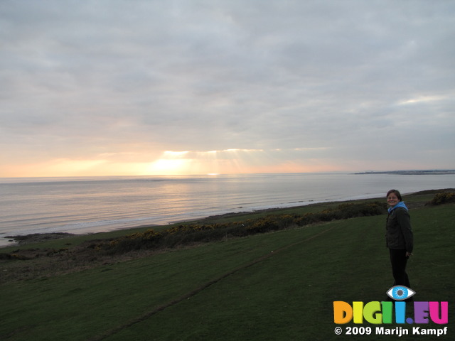 SX03502 Jenni walking down to Ogmore by Sea beach